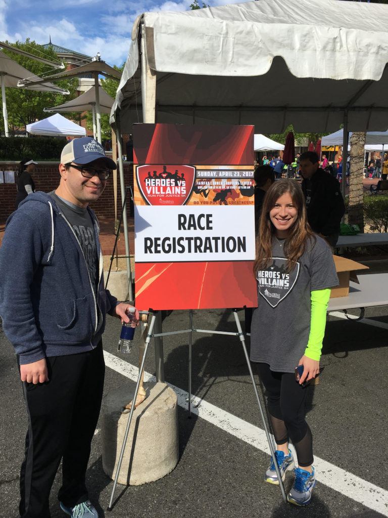 Attorneys Joshua Isaacs and Julie Swerbinsky volunteer at Fairfax Law Foundation’s Heroes vs. Villains 9th Annual Run for Justice 5k.