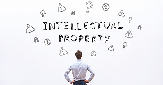 A man stares at the words Intellectual Property, which are written on a board.